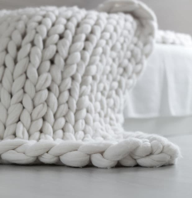 Soft chunky yarn hand-looped into a cozy blanket