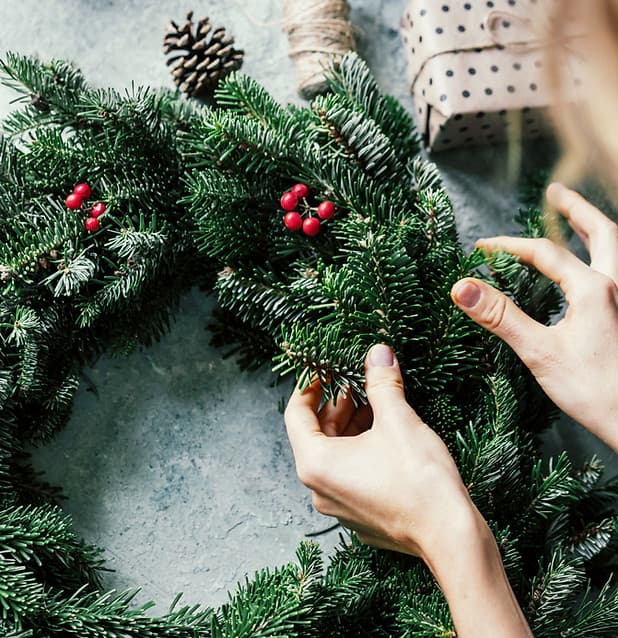 Handmade holiday wreath decorated with seasonal materials