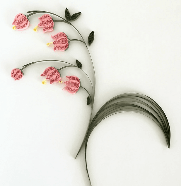 Rolled paper quilling shapes arranged into colorful artwork